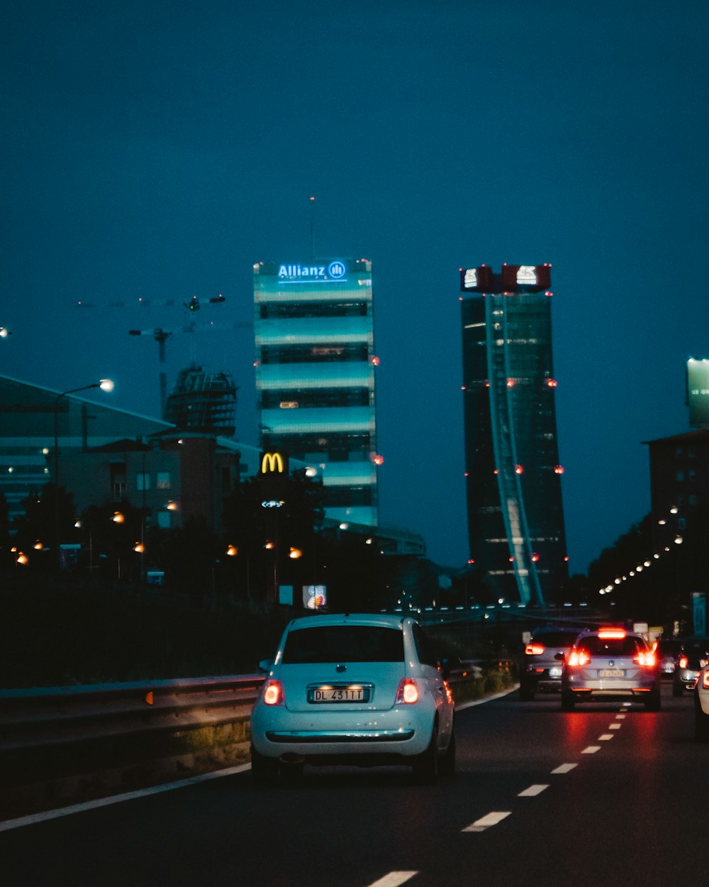 white vehicle on road at nighttime