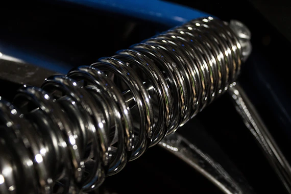 Close-up of metal bellows spring element showing corrugated stainless steel
