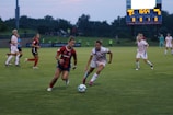A group of soccer players competing intensely on an outdoor field.