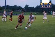 An intense player duel for the ball during a tactical match.