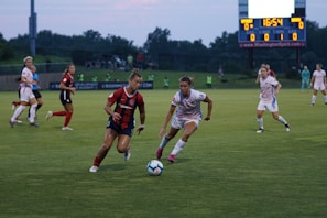 A group of soccer players competing intensely on an outdoor field.