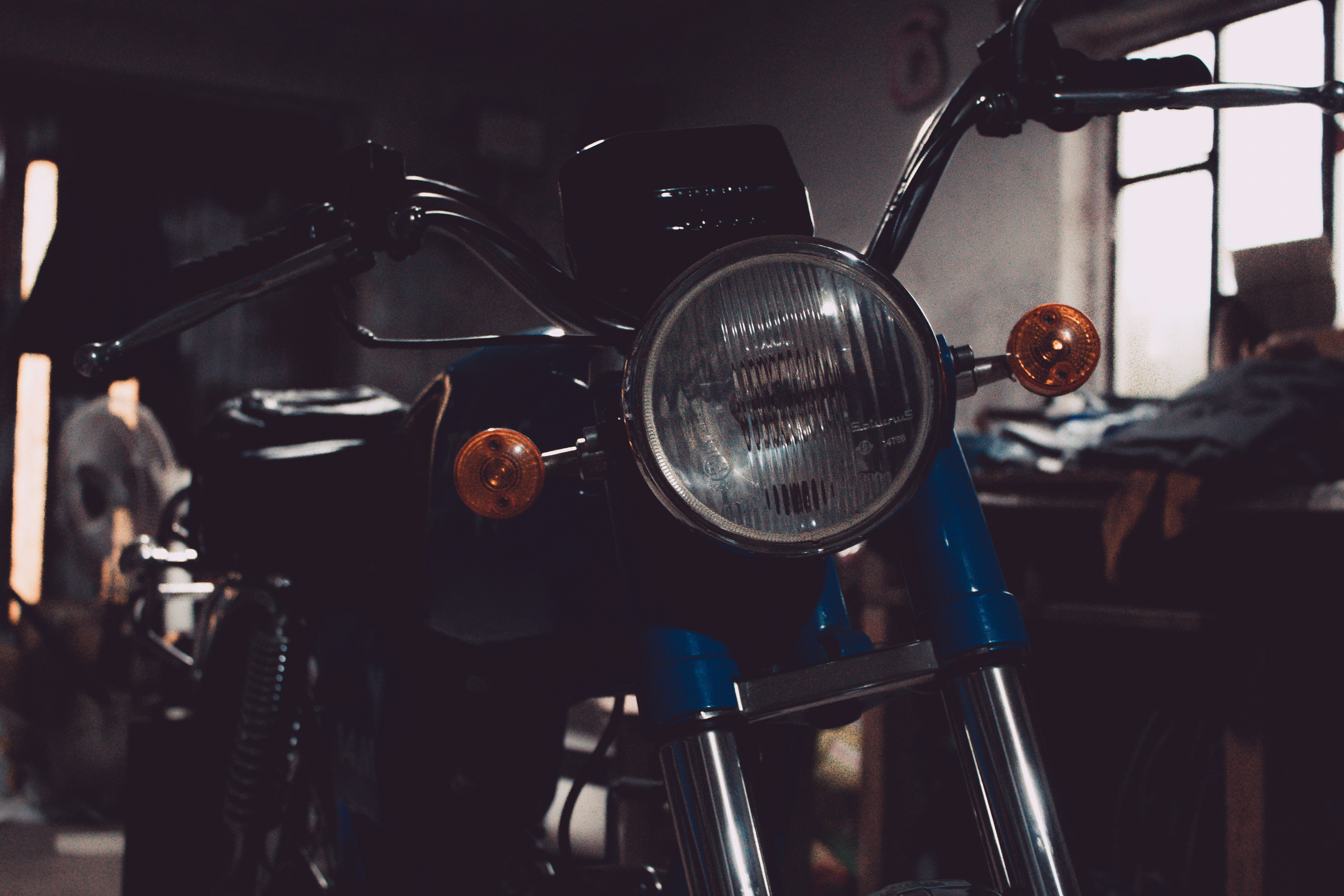 Empty blue standard motorcycle in closeup photo in garage