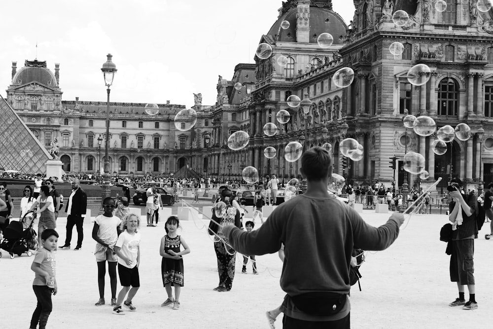 grayscale photography of people near building