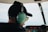 man wearing black top and black baseball cap using green headset