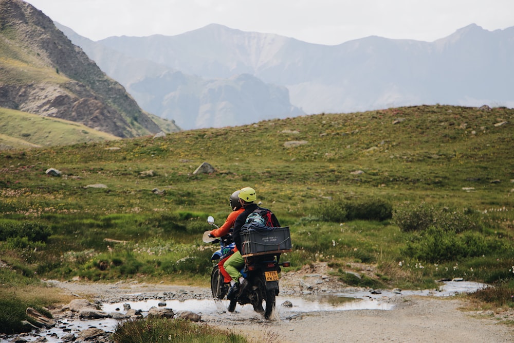 two persons riding motorcycle during daytime