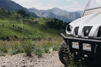A rugged off-road vehicle in a mountainous landscape.