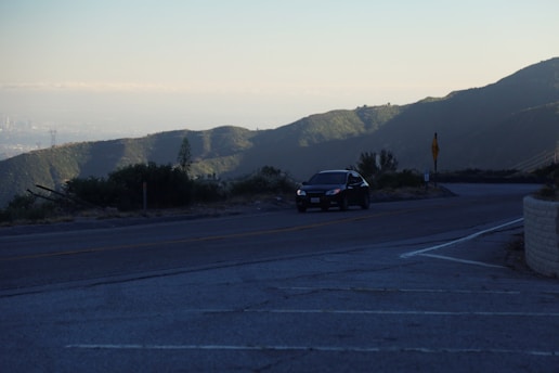 A scenic road winding through Antalya and Muğla landscapes with a transfer vehicle driving smoothly.