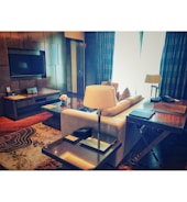 Bright, modern living room with elegant furnishings and warm lighting