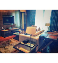 Spacious living area with plush seating and a flat-screen TV.