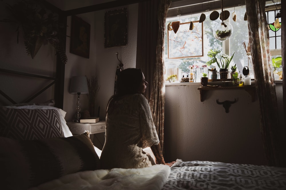 woman sitting on bed