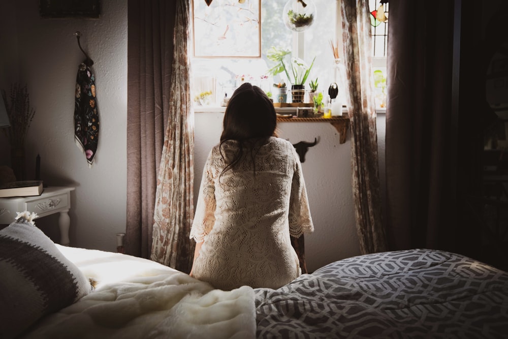 woman sitting on bed