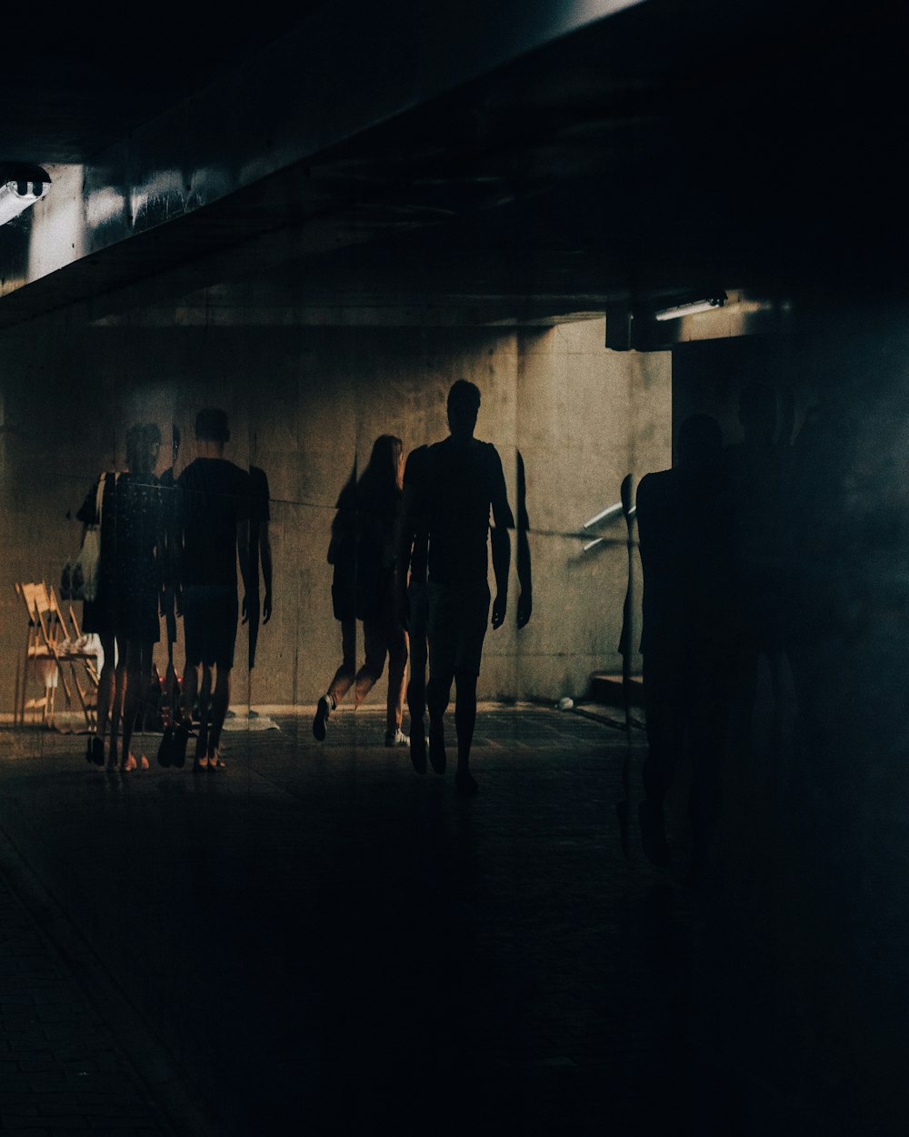 silhouette of people walking near building