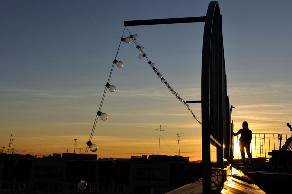 silhouette of person standing during sunset