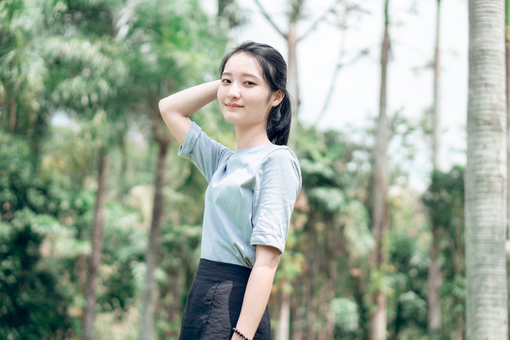 woman wearing gray blouse and gray miniskirt