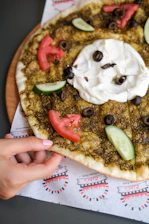 A warm, golden manakish topped with zaatar herbs fresh from the oven.