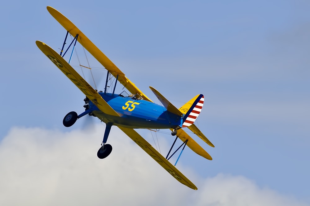 blue and yellow biplane