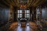 A dimly lit room with ornate chandeliers and rich decor.