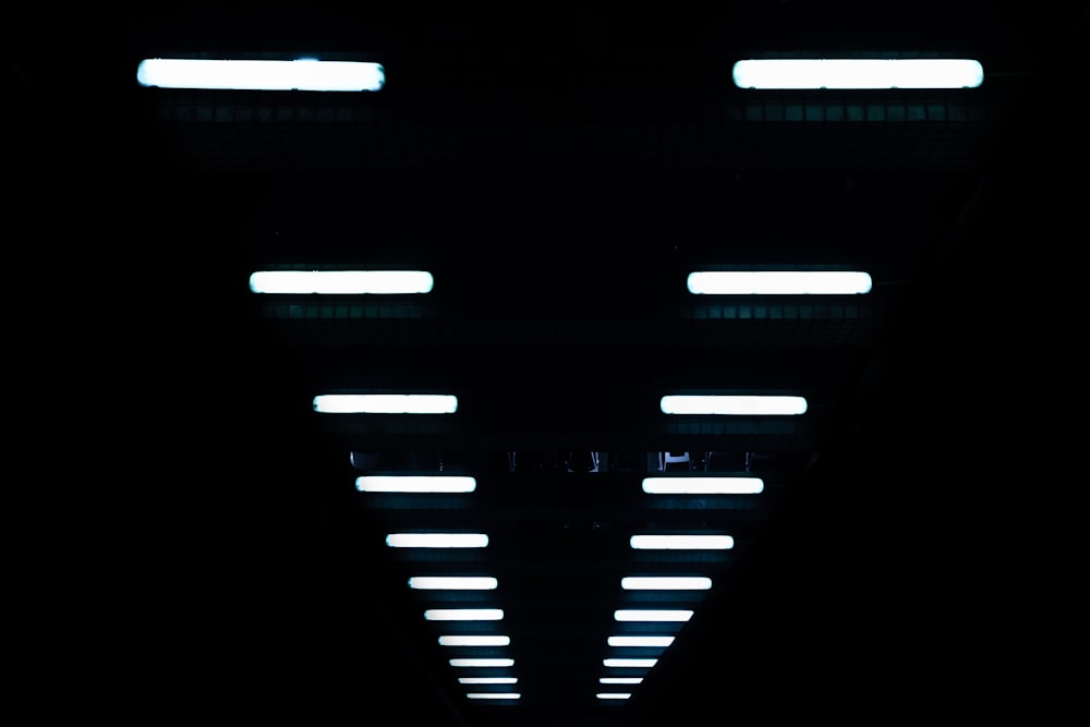 a dark tunnel with lights on the ceiling