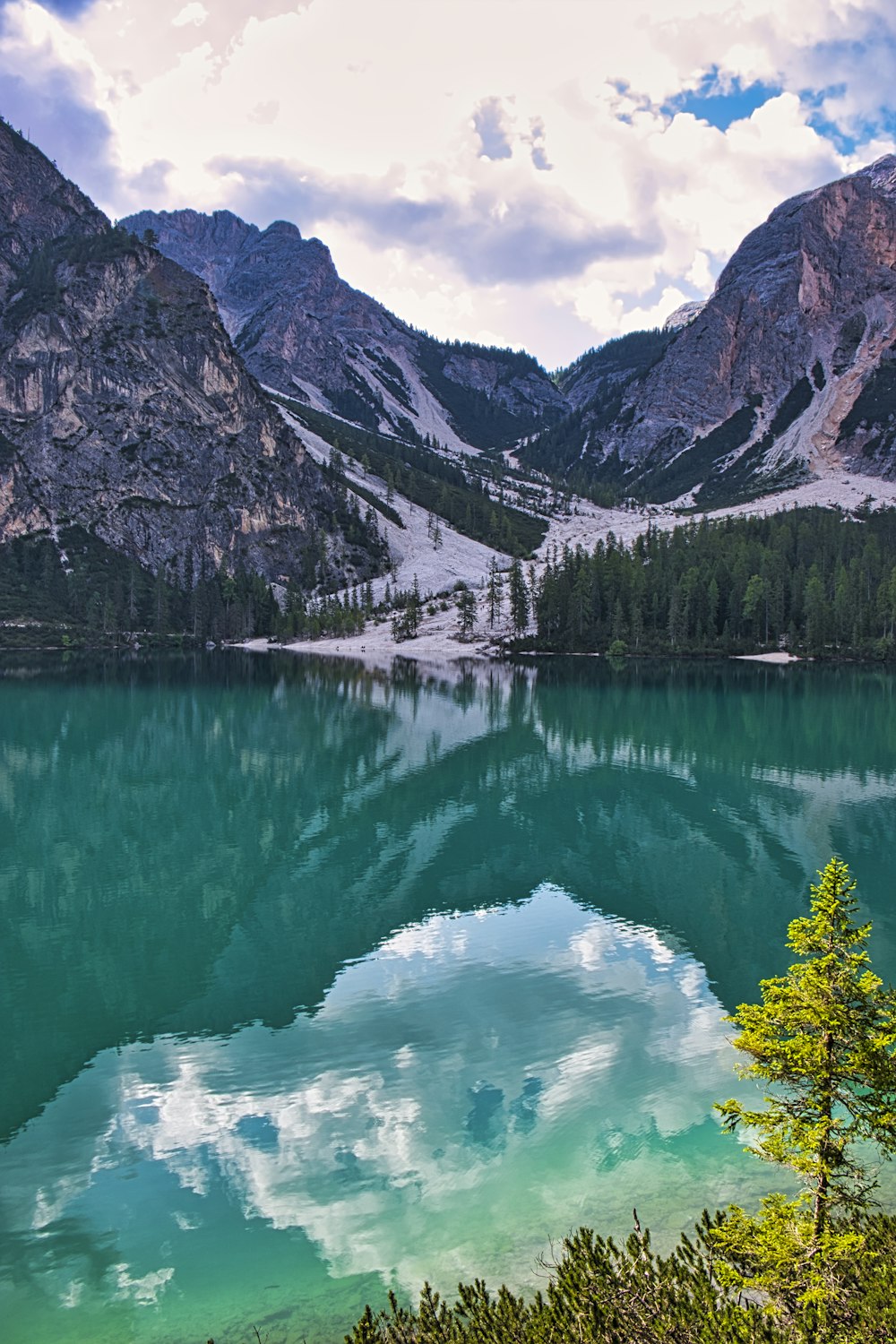 body of water near mountain during daytime