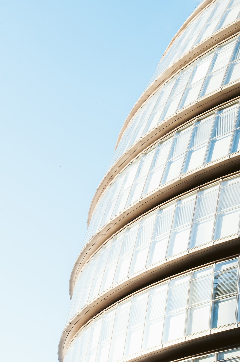 a tall building with many windows and a sky background