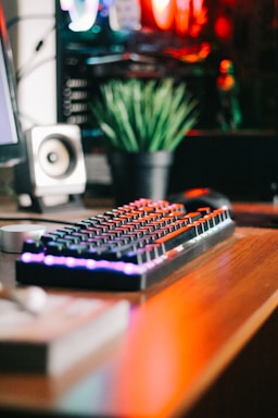 A cozy workspace featuring a sleek mechanical keyboard with colorful keycaps and a warm desk lamp.