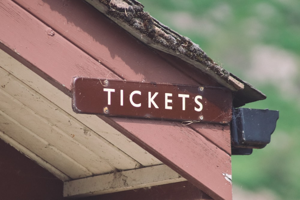 tickets signboard on wooden surface