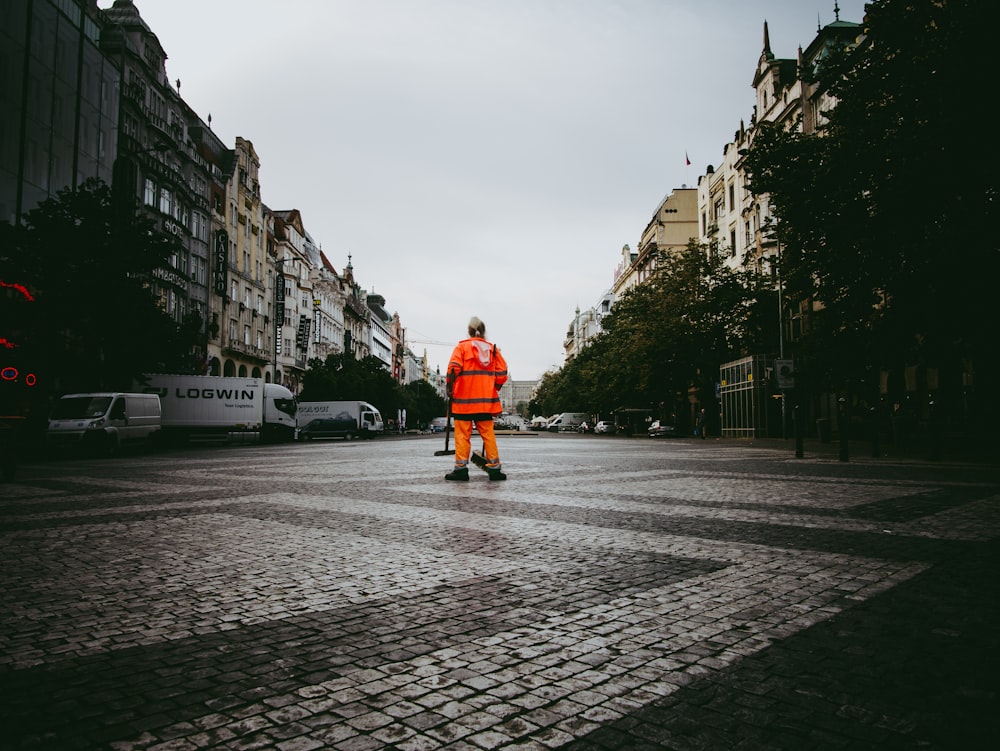 man standing on gray pathway