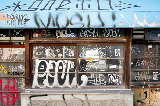 Custom artwork featuring the Squeegenators logo painted on a window, blending art and cleanliness.