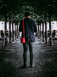 men's black coat and gray denim jeans