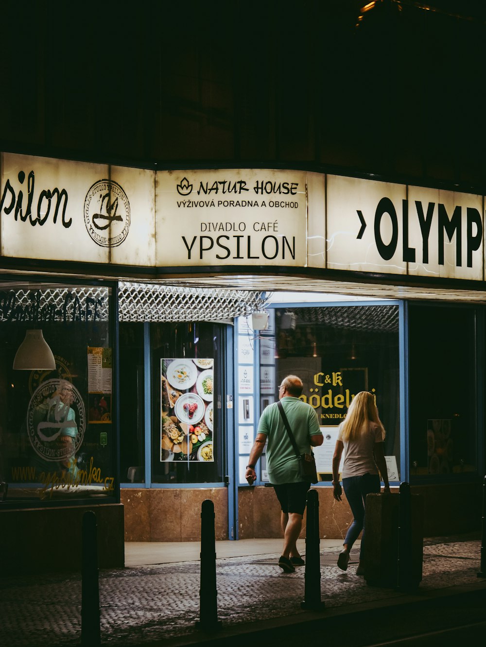 man and woman walking outside store