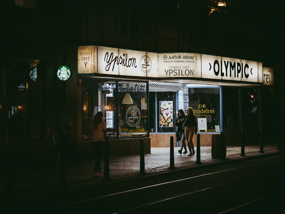 two women walking beside store