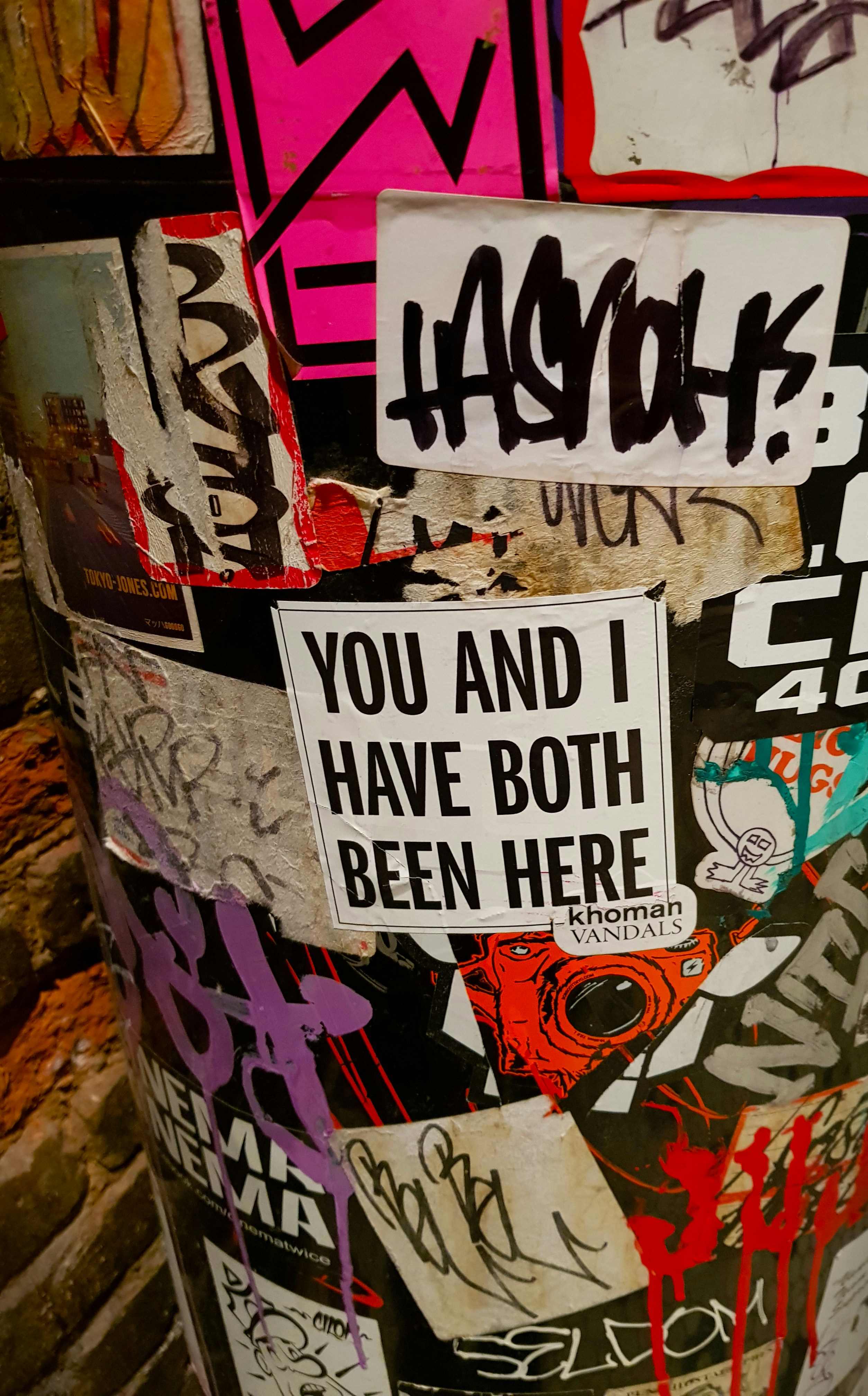 a trash can covered in graffiti and stickers