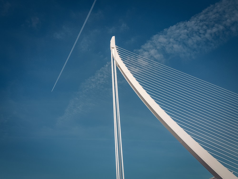 white concrete tower under blue and white skies