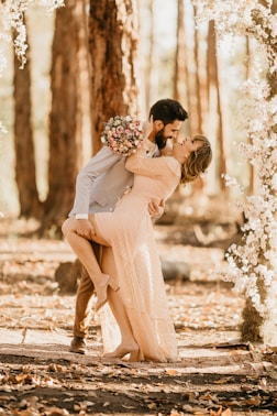 wedding couple surrounded by pink petaled flowers