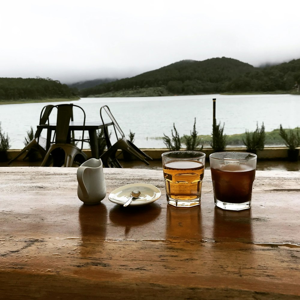 two drinking glass beside plate