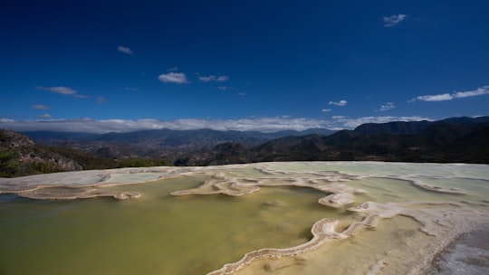 aerial photography of body of water under calm blue sky in Hierve el Agua Mexico