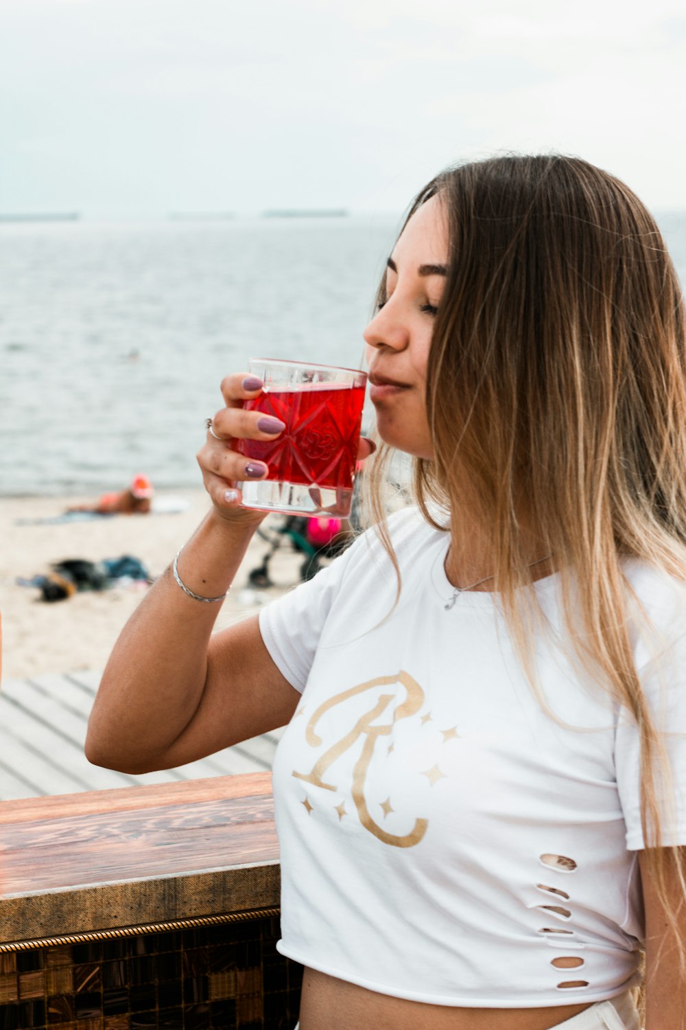 woman standing and about to drink juice