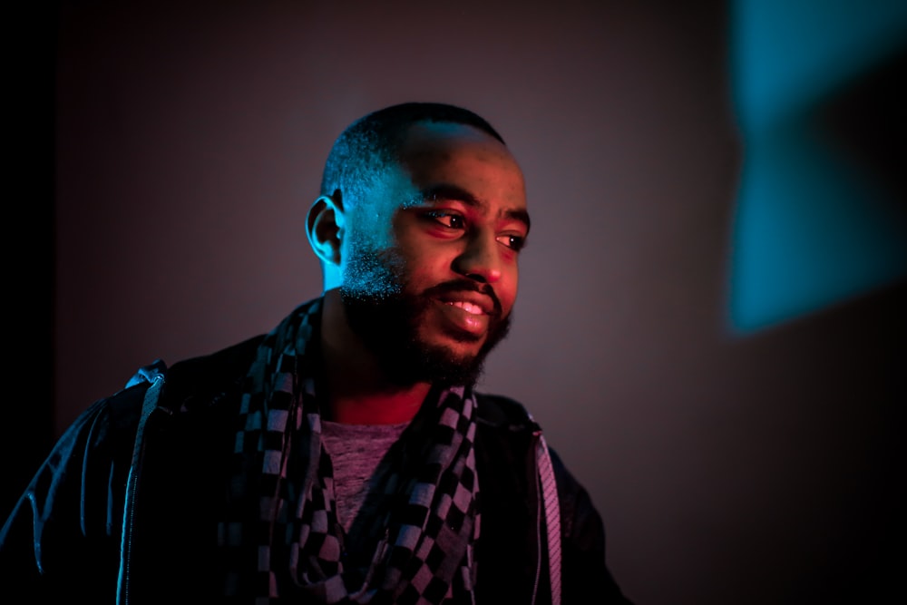 man wearing black and white checkered scarf