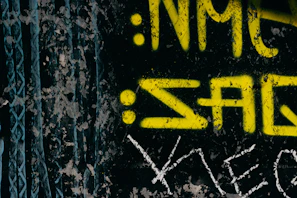 Hand-drawn rock band logo on a torn black paper background.