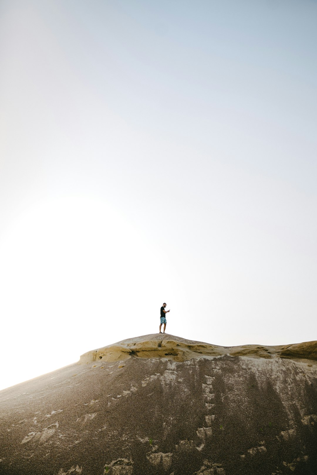 person standing on top of mountain]