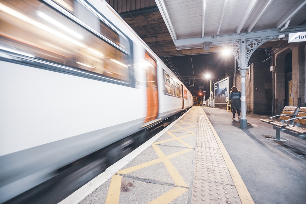 woman beside white train