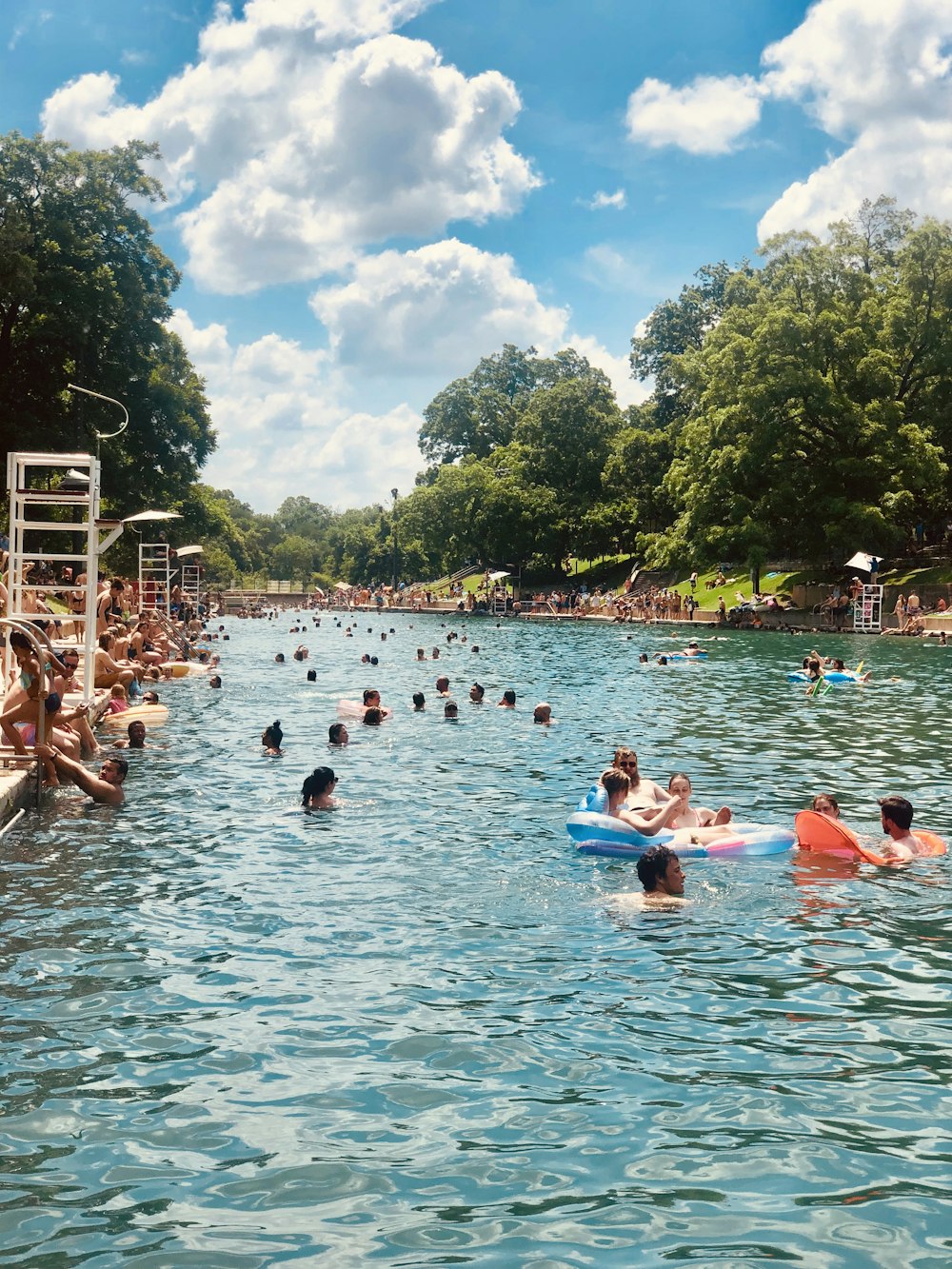 people on river under clear blue sky