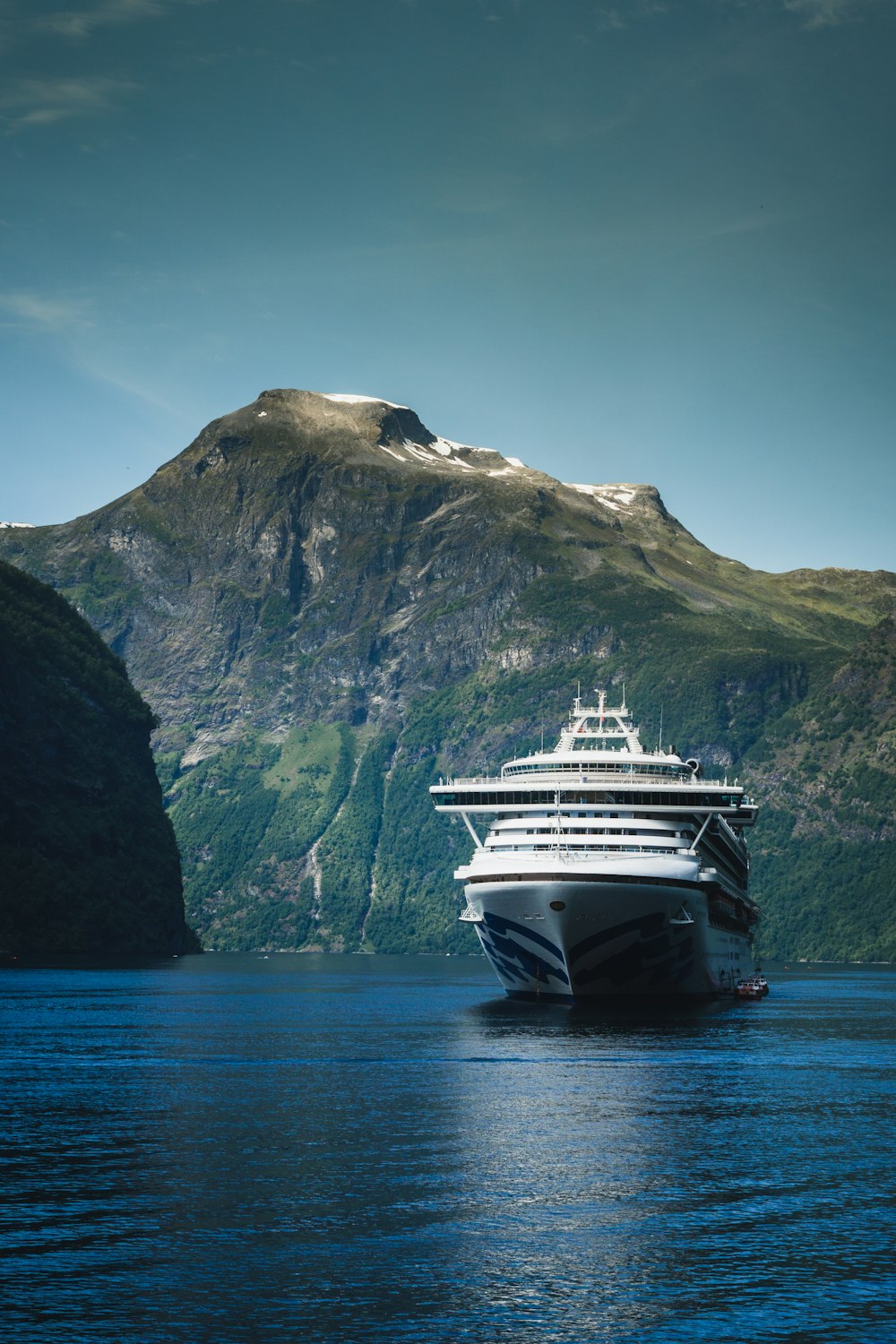 cruise ship near mountain during daytime