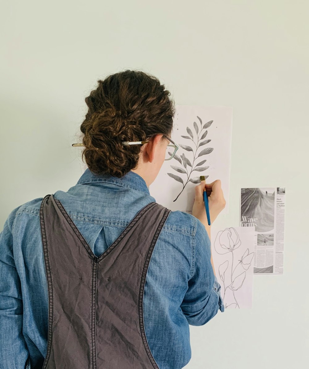 woman painting on wall