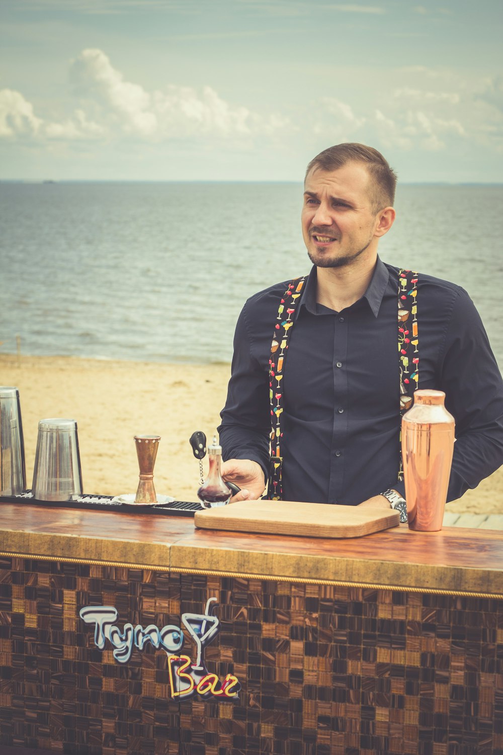 man standing beside desk near shore