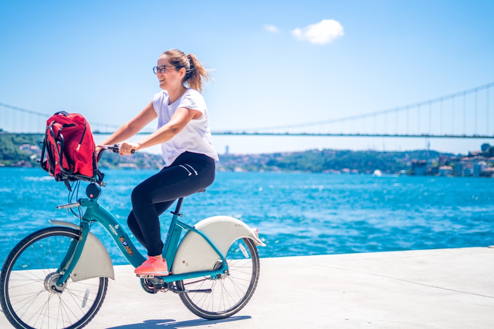 woman riding bicycle on dock