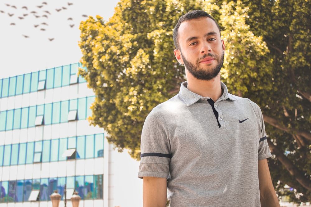 man wearing gray Nike collared t-shirt