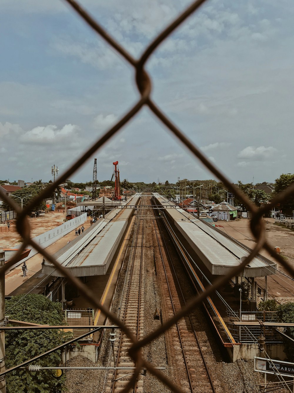 brown railway under clear blue sky