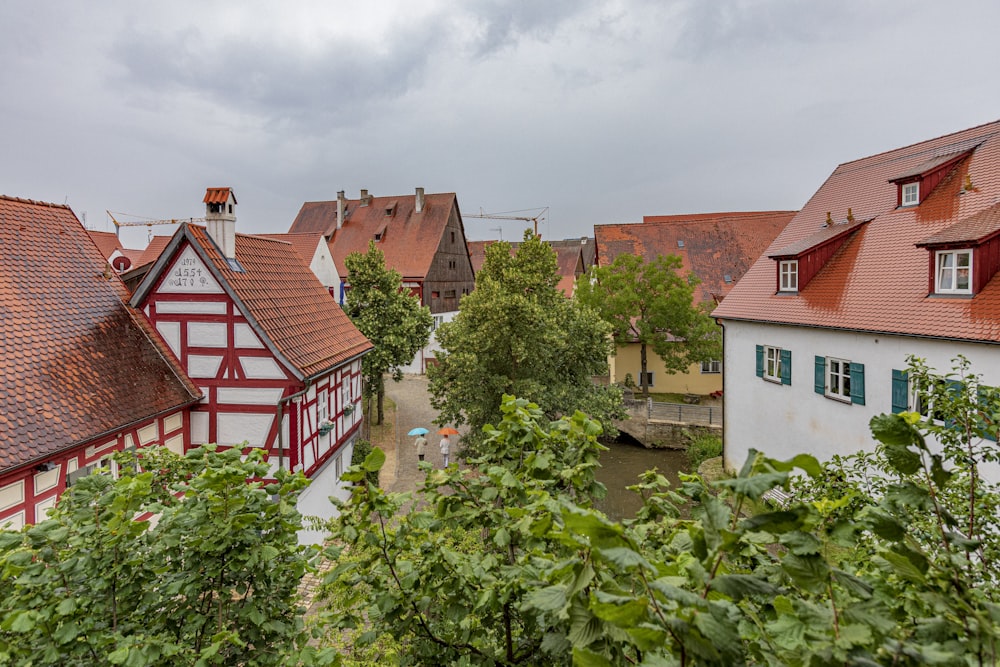 white and brown houses under cloudy sky