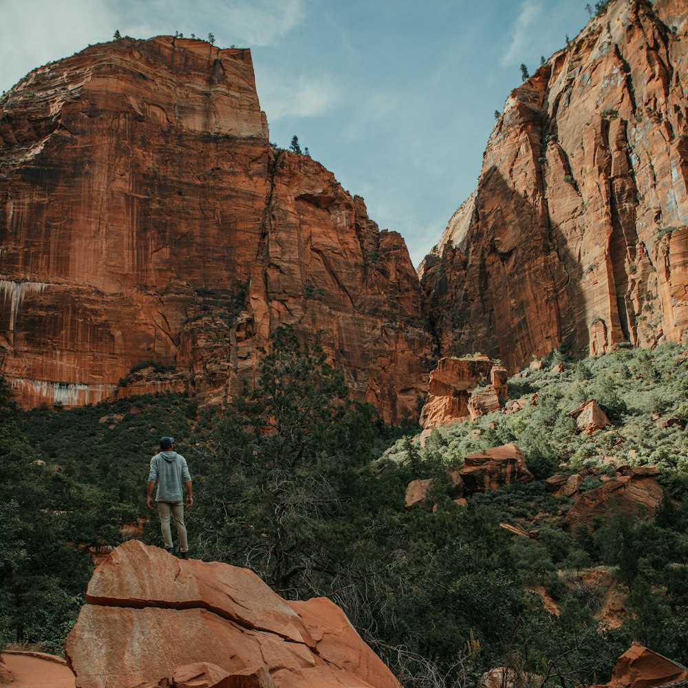 man standing on rock formation